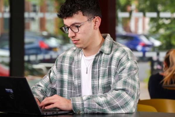 male sitting on laptop